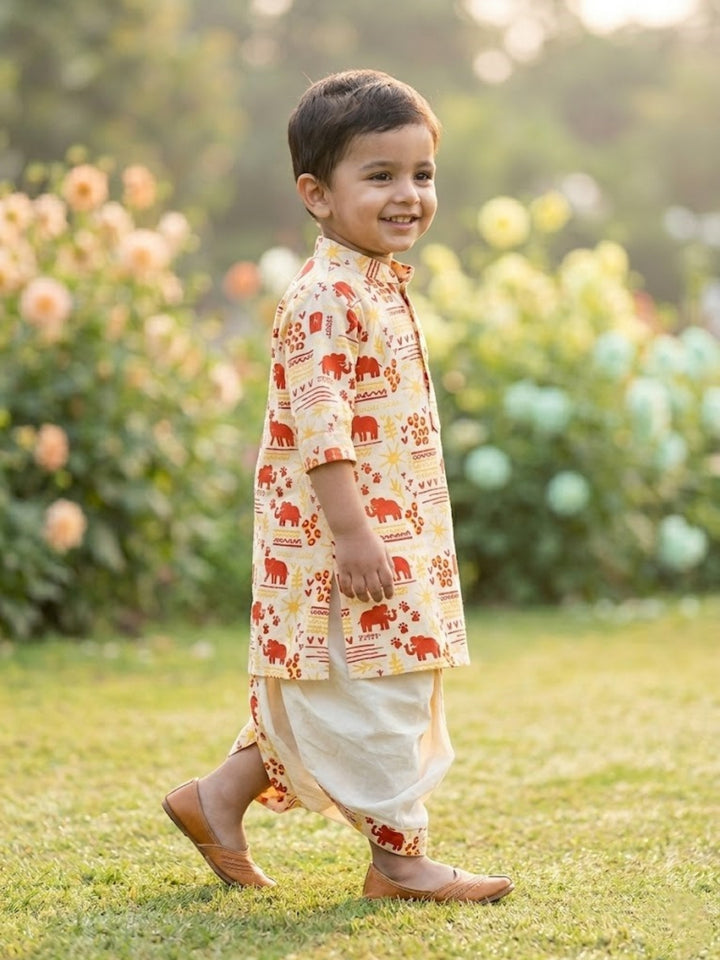 Child wearing a Dhoti Kurta with elephant patterns in a garden setting